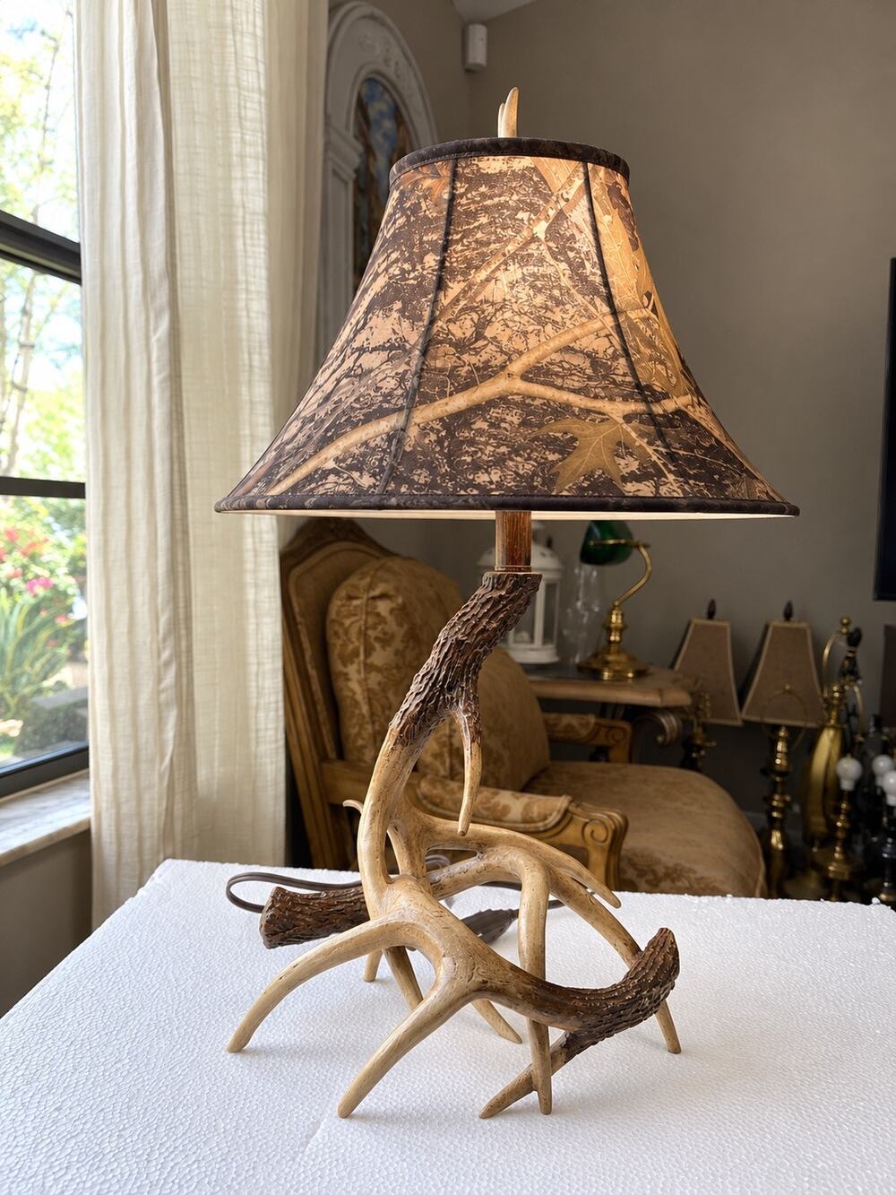 rustic table lamp featuring a base made of camo-patterned fabric lampshade
